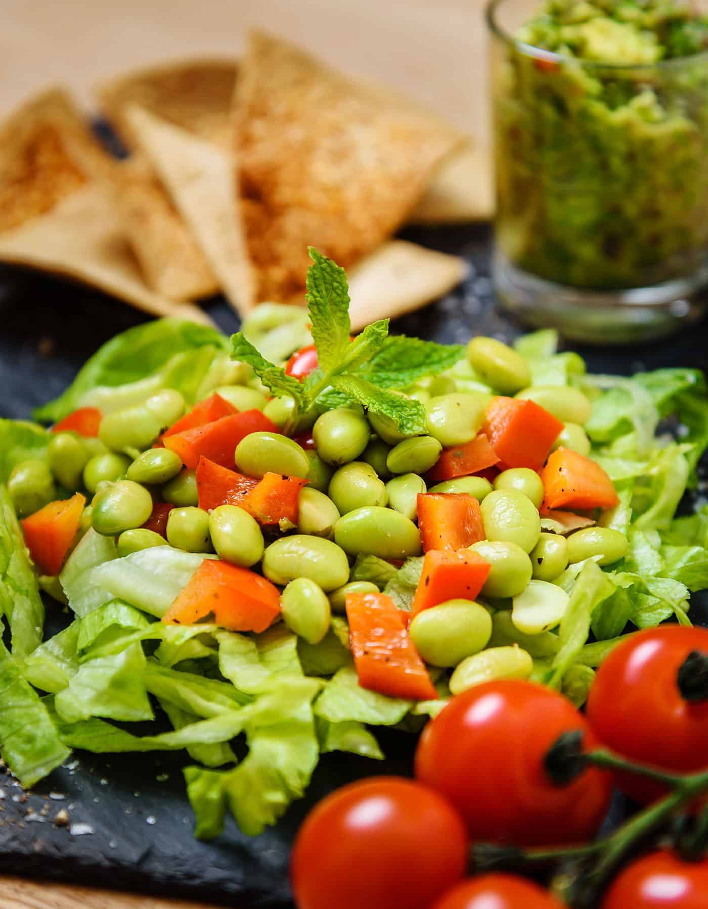 Close up of Warm Edamame Salad served with Guacamole and Home-baked Tortillas