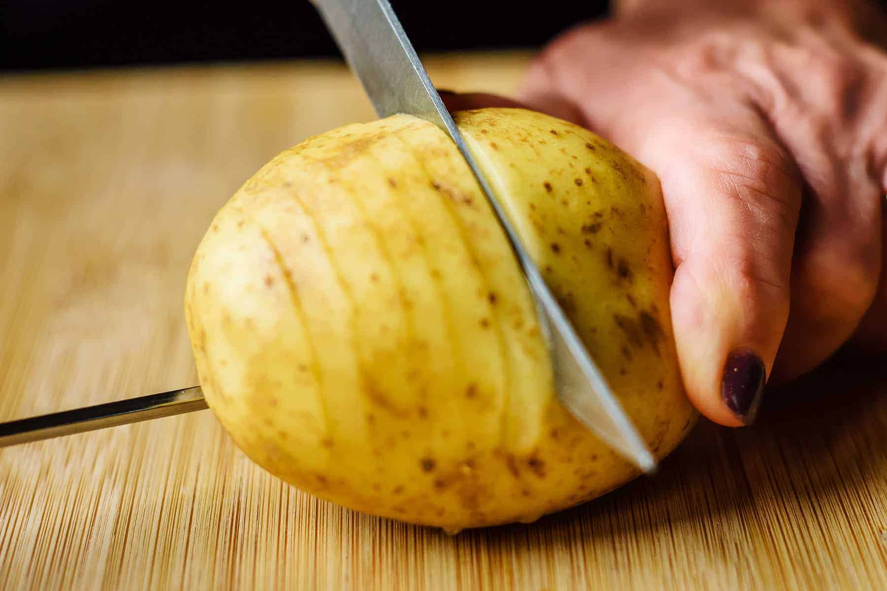 Continue slicing through potato stopping at skewer