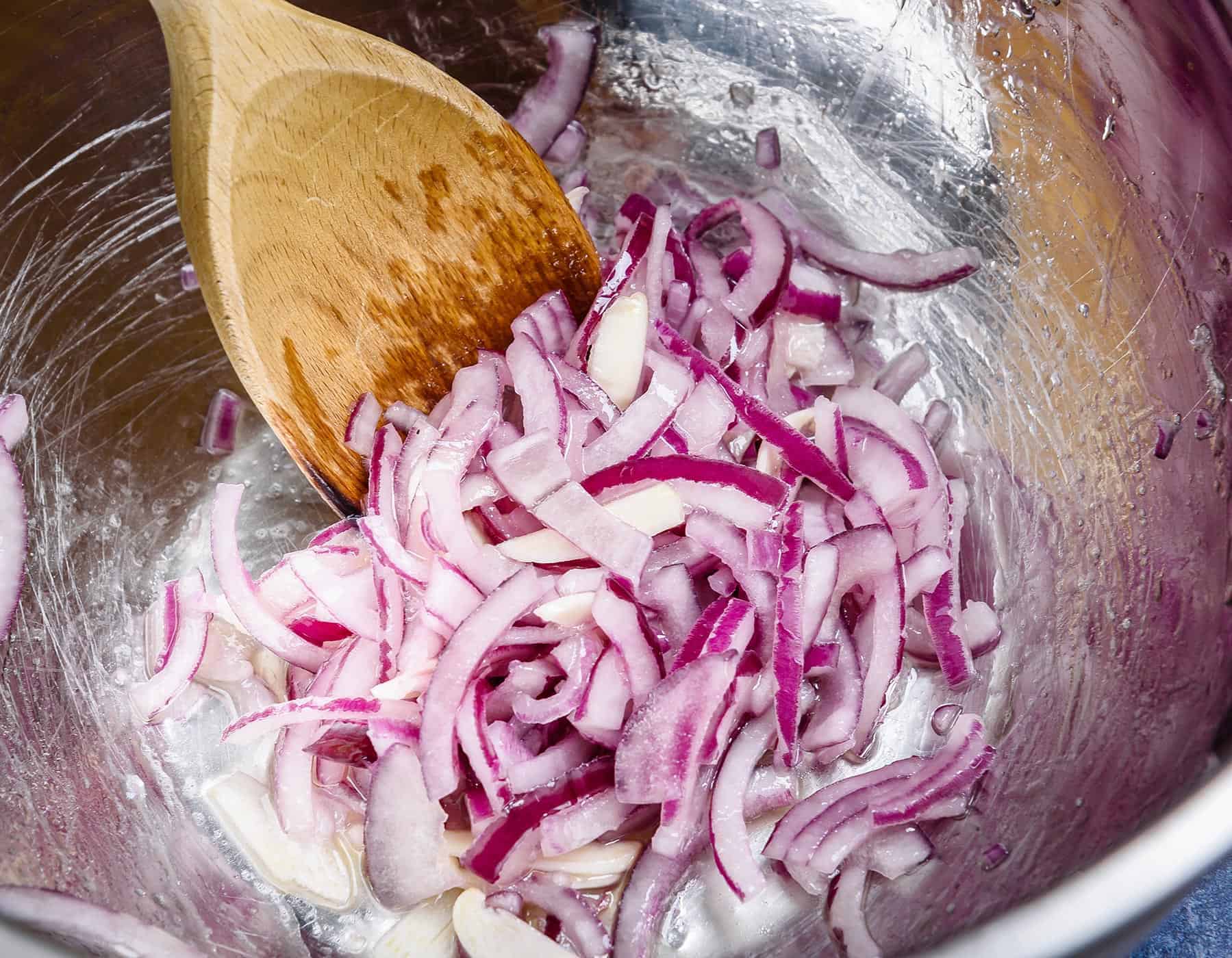 Mixing the onion and garlic in oil