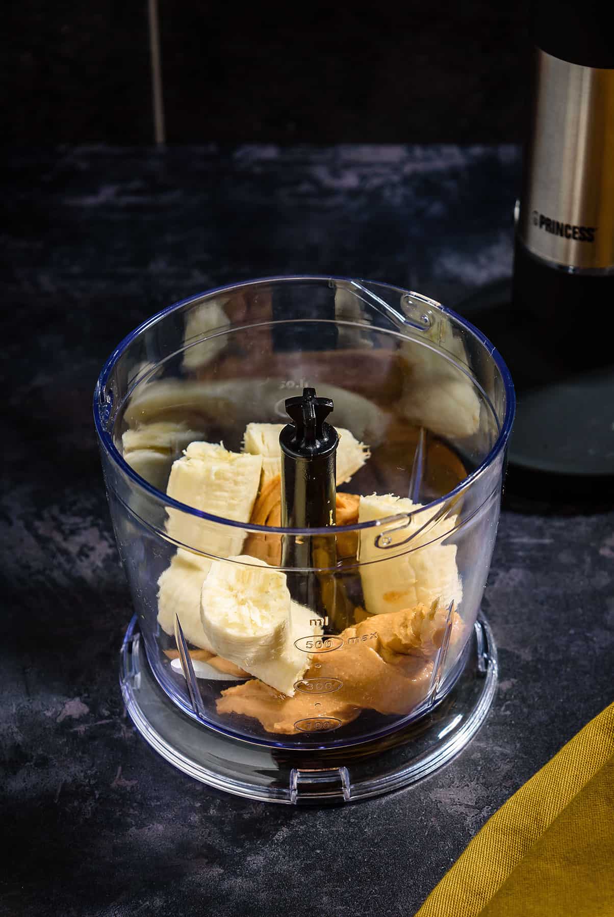 Peanut-butter and banana in blending bowl