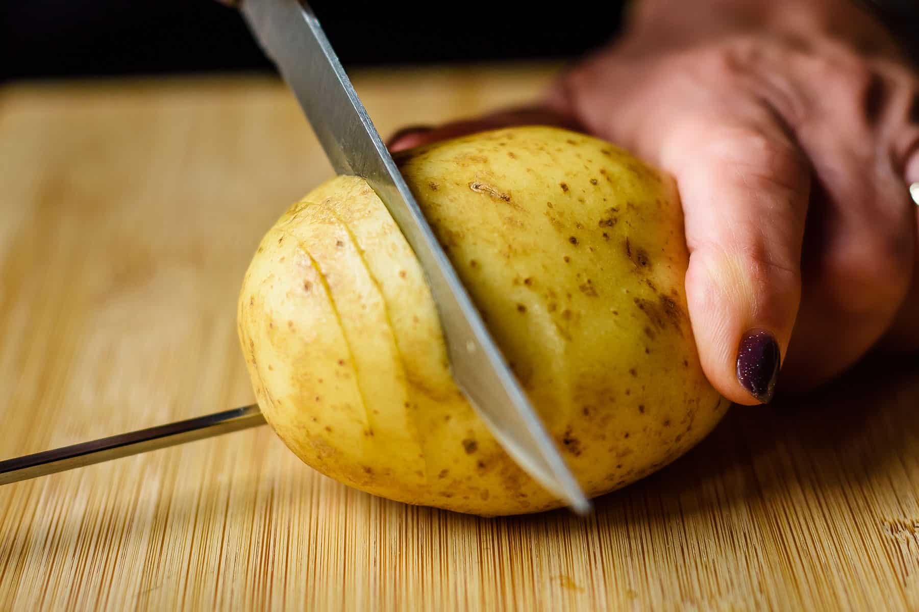 Starting to slice through potato from one end