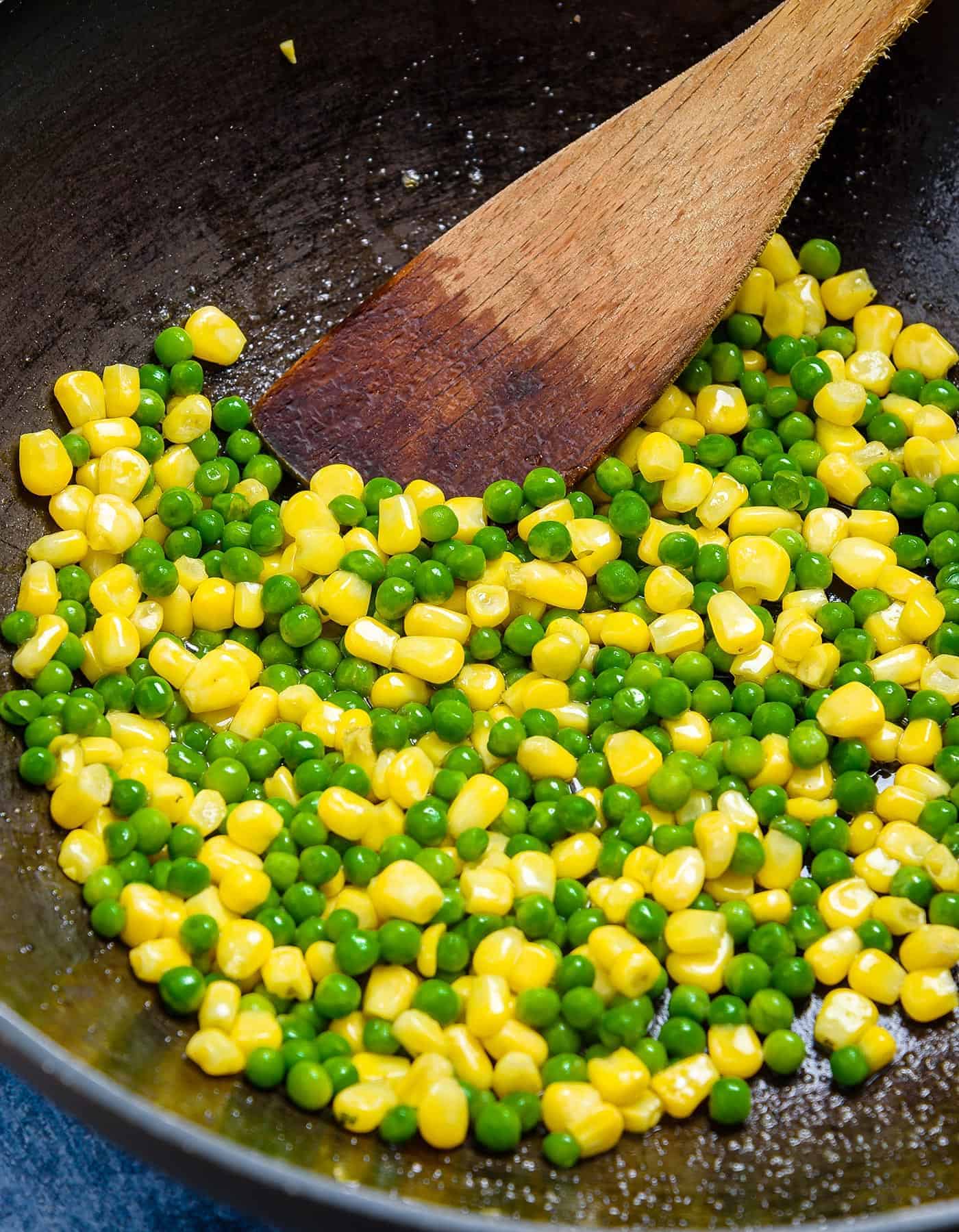 Stir-frying the peas and sweetcorn