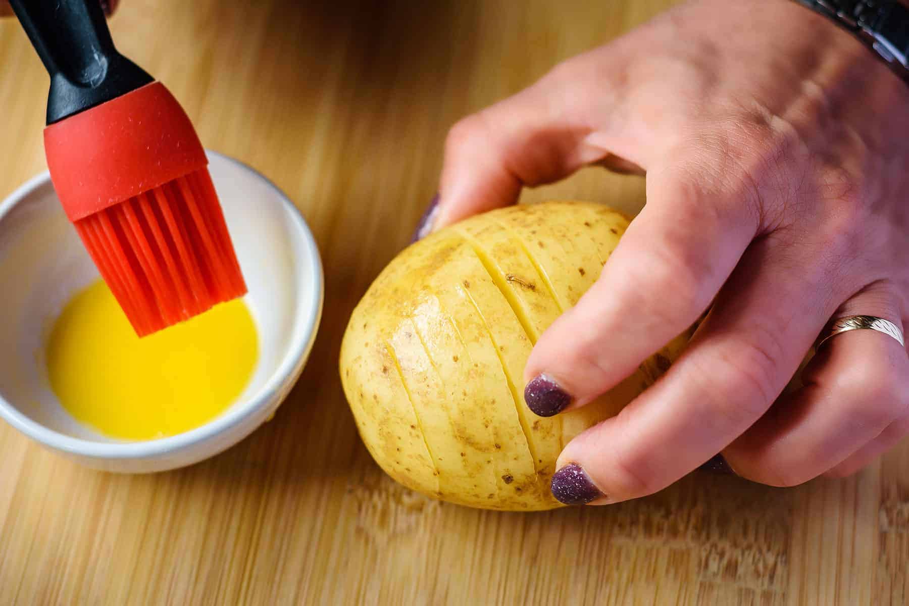 Using hand to separate slices to apply butter
