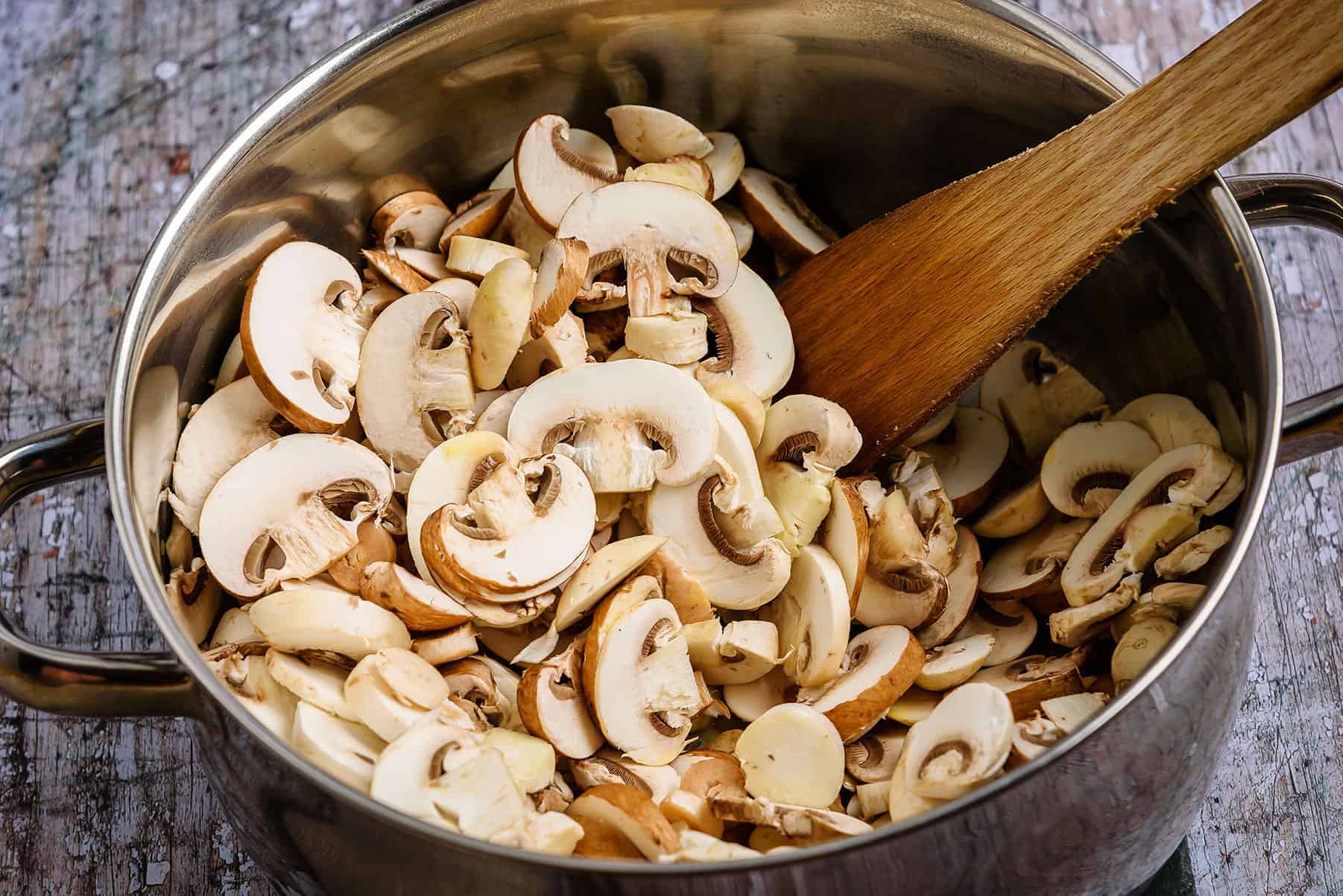 Adding the mushrooms to pan