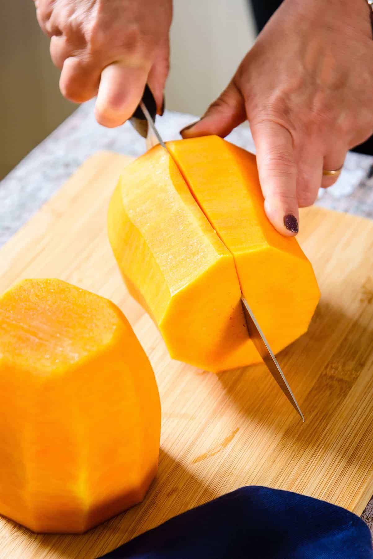 Cutting the peeled squash in half