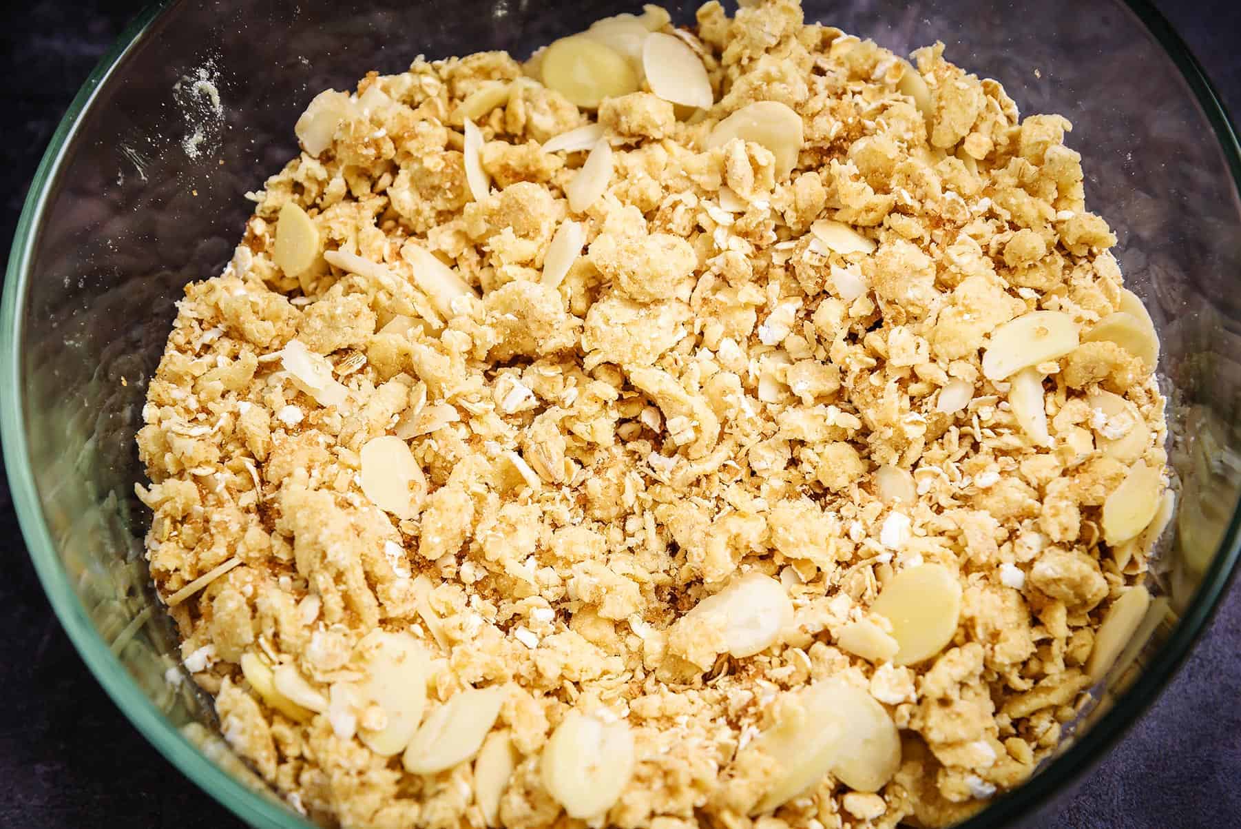 Crumble mixture in a bowl with almonds and sugar mixed in