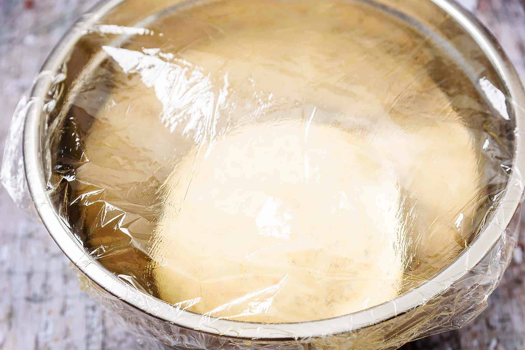 Dough in a bowl covered with oiled cling-film