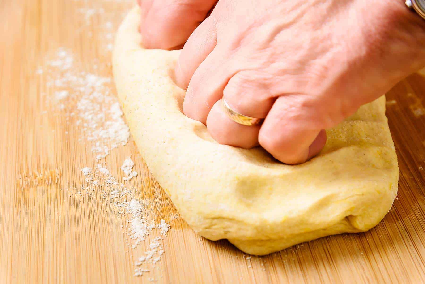 Knocking back the dough after proving