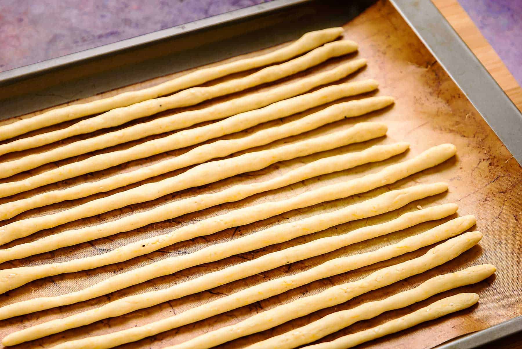 Rolled dough into long thin strips for baking