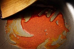 Oil and smoked paprika mixed in a frying pan