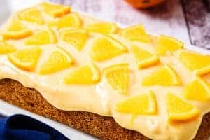 Vegan Orange Butter Icing with orange segments on a cake