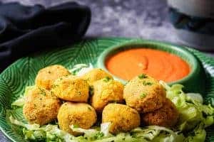 Cooked Vegan Cheesy Rice Balls with a dip