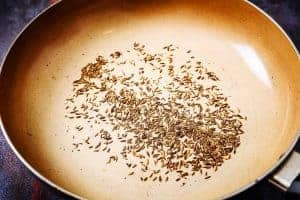 Toasted cumin seeds in a pan