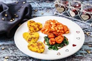 Vegan Sausage & Bacon Polenta served with cherry tomatoes, spinach, and beans