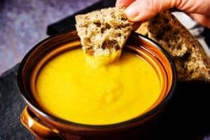 Dipping bread into Vegan Curried Parsnip Soup