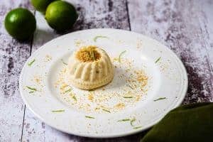 Lime & Ginger Cheese Cakes decorated with biscuit crumbs and lime zest