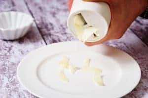 Pampered Chef Garlic Slicer sliding garlic onto a plate
