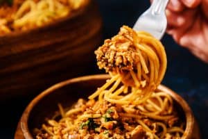 Smoky Mushroom & Tofu Bolognese on a fork with spaghetti