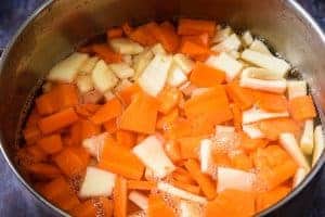 Carrot and parsnip batons in a saucepan of water