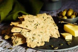 Rye & Pumpkin Seed Crackers served with cheese and olives