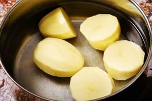 Potatoes in a pan of cold water